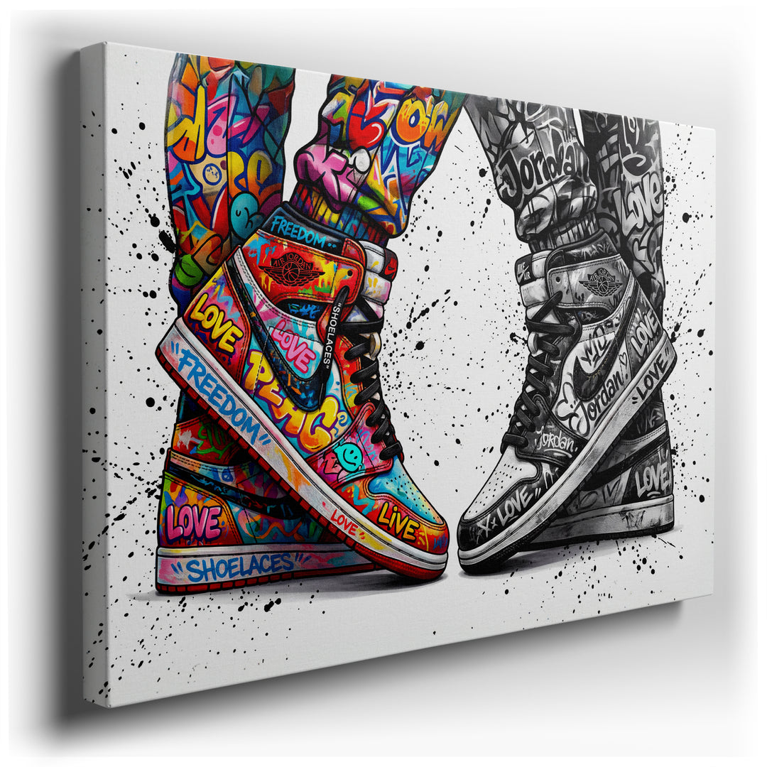 Canvas art featuring two sneakers: one vibrant with colorful graffiti and positive words, the other in black and white street art style.
