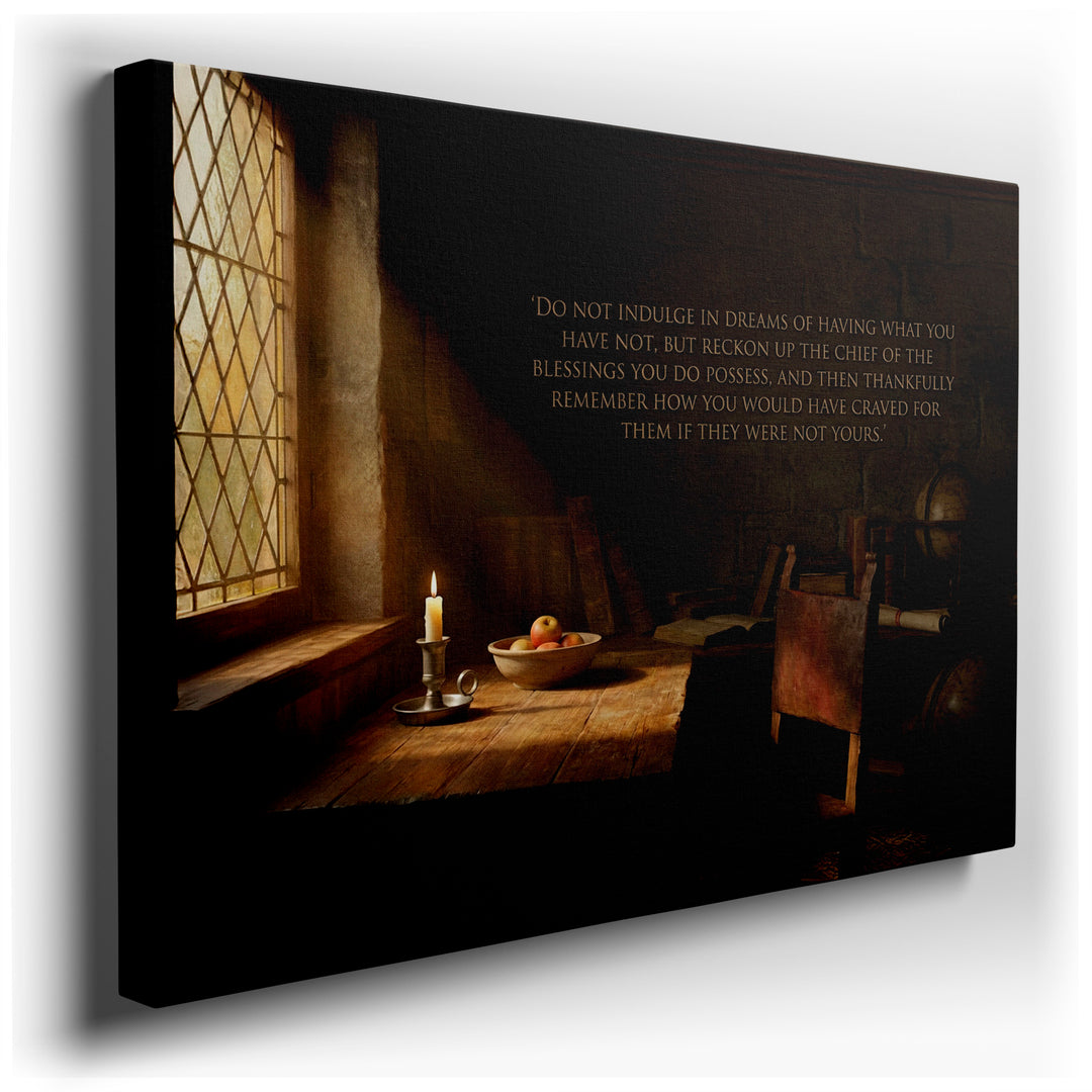 A vintage study shows a sunlit desk with a candle, books, apples, & a quote on a canvas wall art piece.