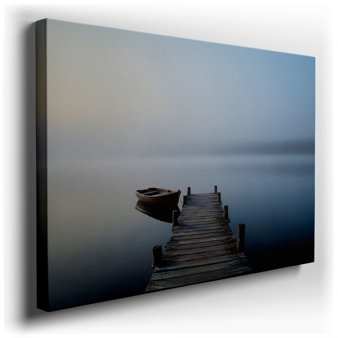 A serene image of a wooden dock leading to a boat on a misty lake, beautiful wall art and a calming wall decor piece.