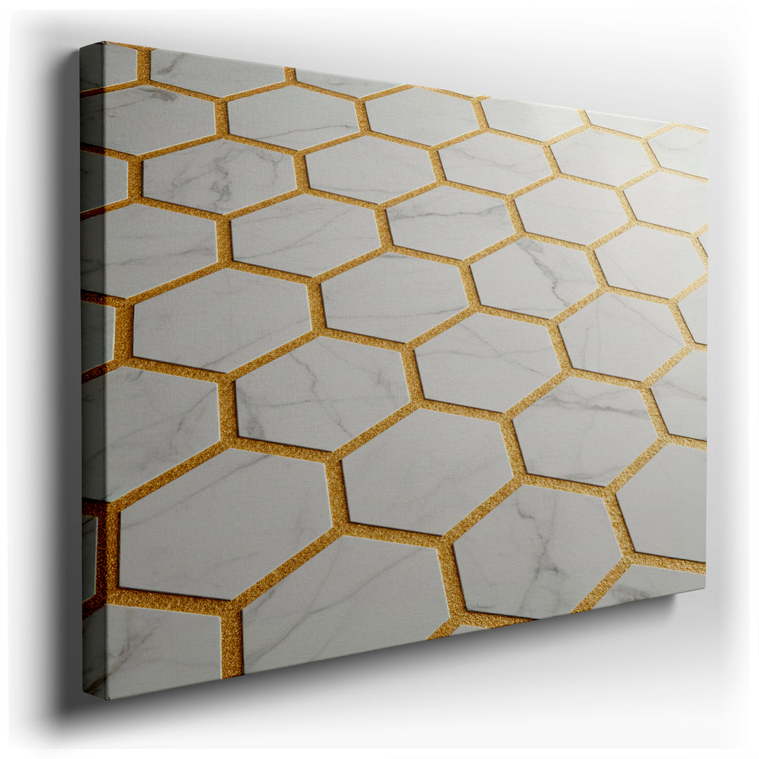 Close-up of geometric wall art featuring white marble hexagons with sparkling gold grout lines on a canvas.