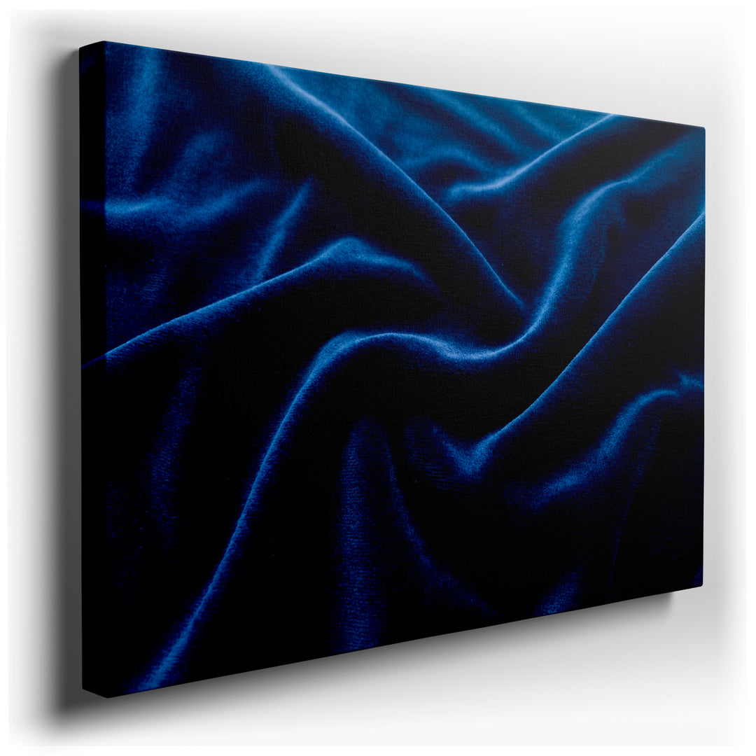 A close-up shows the texture of draped, deep blue velvet, ideal as modern wall art showcasing depth and rich color.