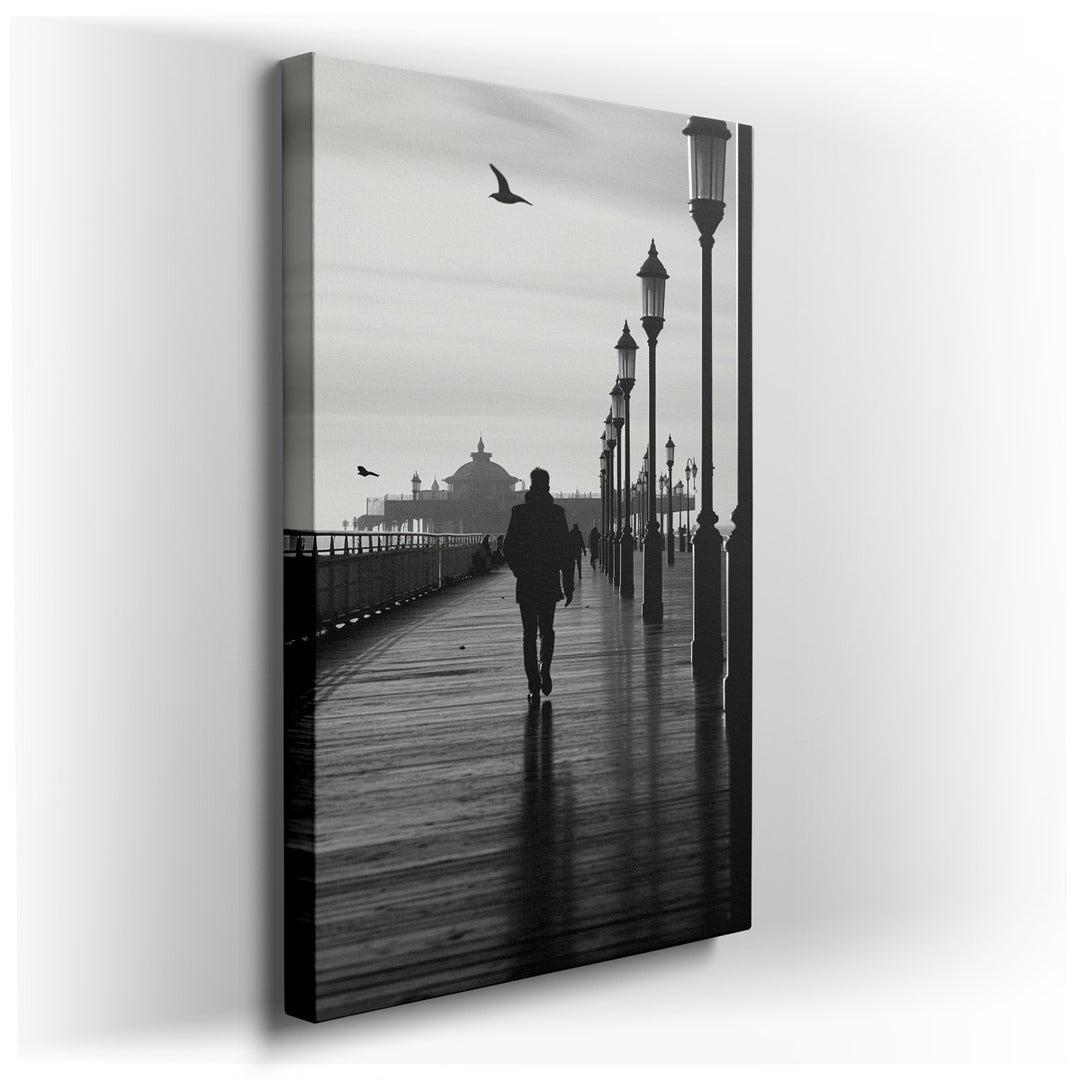 canvas print on wrapped canvas for wall decor – This evocative black-and-white wall art captures a solitary figure ambling down a deserted pier, a scene that is both ti...