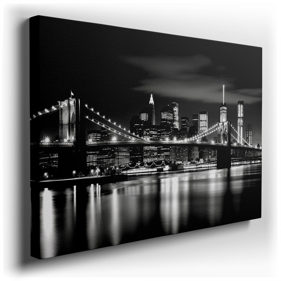 canvas print on wrapped canvas for wall decor – This captivating black and white photograph of the Brooklyn Bridge, set against a dramatic nighttime backdrop, is a mast...