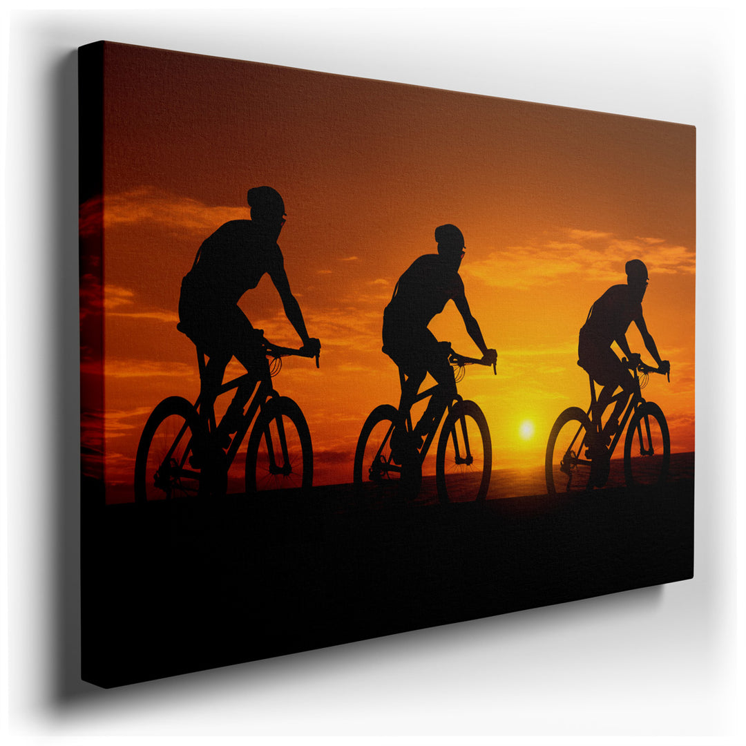 canvas print on wrapped canvas for wall decor – This captivating wall art portrays a trio of cyclists in motion, set against a breathtaking backdrop of a vibrant sunset...