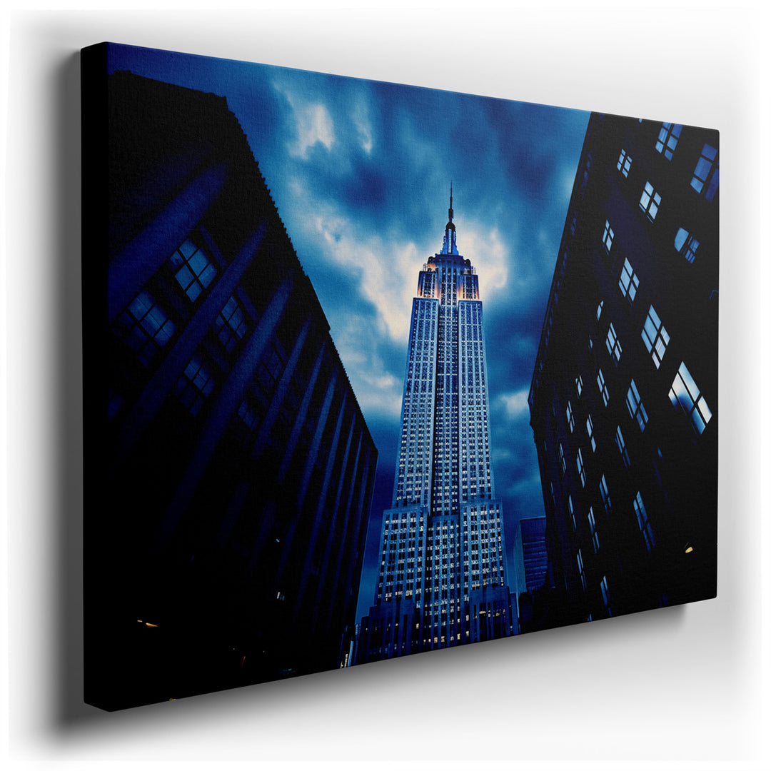 canvas print on wrapped canvas for wall decor – This wall art captures the essence of New York City through its dramatic depiction of the Empire State Building, one of...