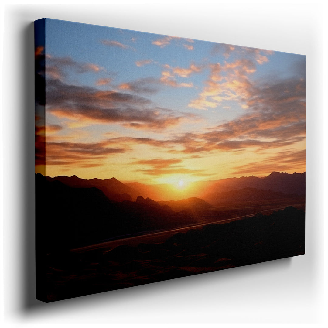 canvas print on wrapped canvas for wall decor – This wall art captures a breathtaking scene of a dramatic sunset over a rugged desert landscape, where the interplay of...