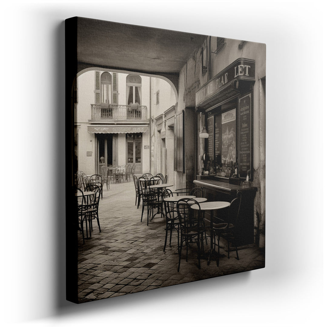 canvas print on wrapped canvas for wall decor – This wall art, rendered in striking black and white, captures the essence of a serene and inviting European café, nestle...