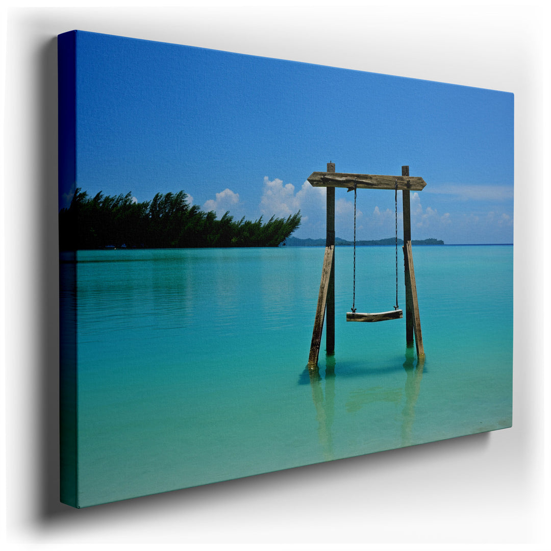 canvas print on wrapped canvas for wall decor – This enchanting wall art captures the essence of a tranquil beach setting, where a lone swing hangs invitingly over the...