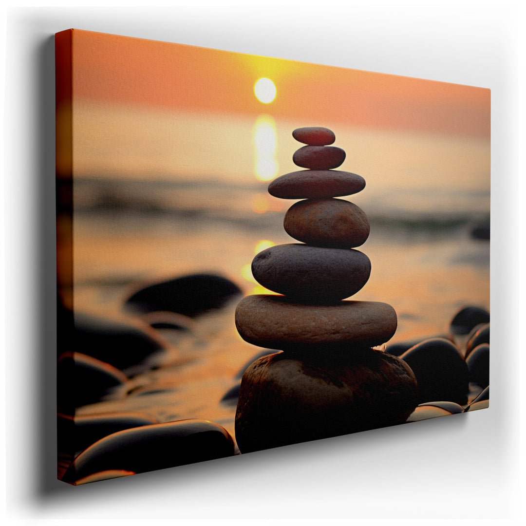 canvas print on wrapped canvas for wall decor – This exquisite wall art captures a tranquil scene on a serene beach at sunset, where a stack of smooth, rounded stones s...