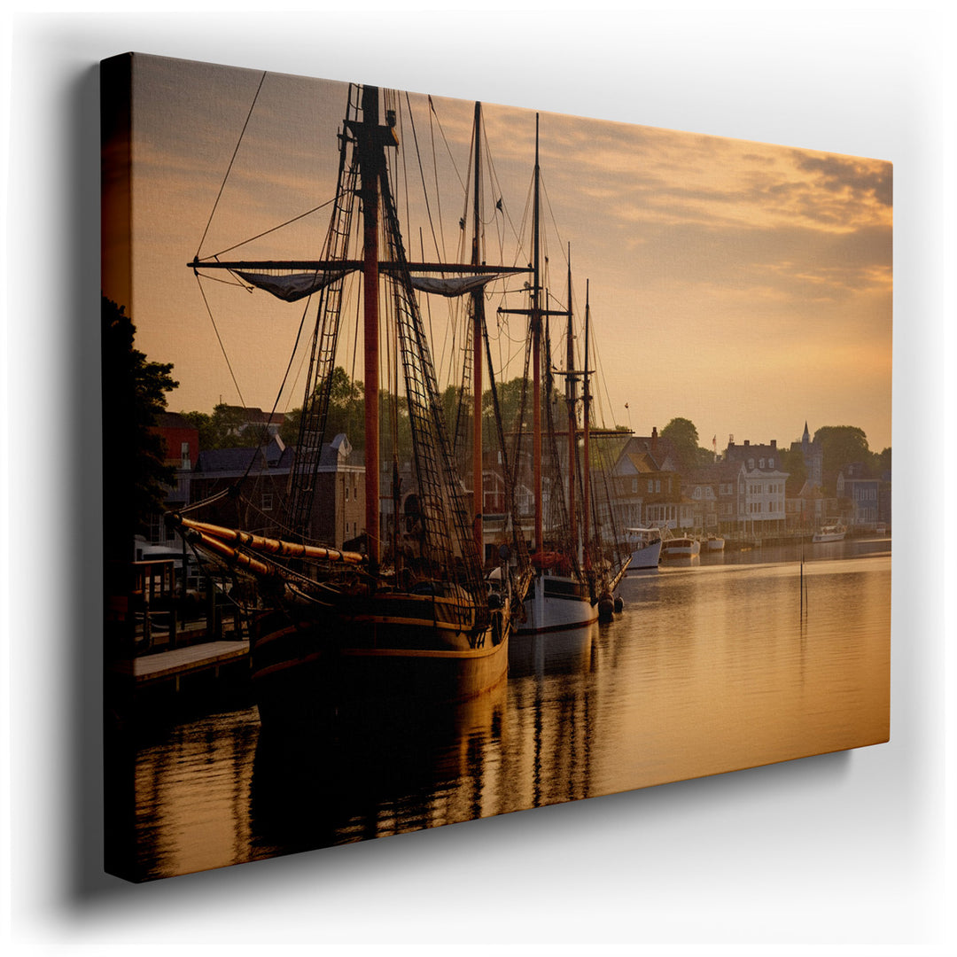 canvas print on wrapped canvas for wall decor – This captivating wall art portrays a serene harbor at the break of dawn, where traditional sailing ships are moored gent...