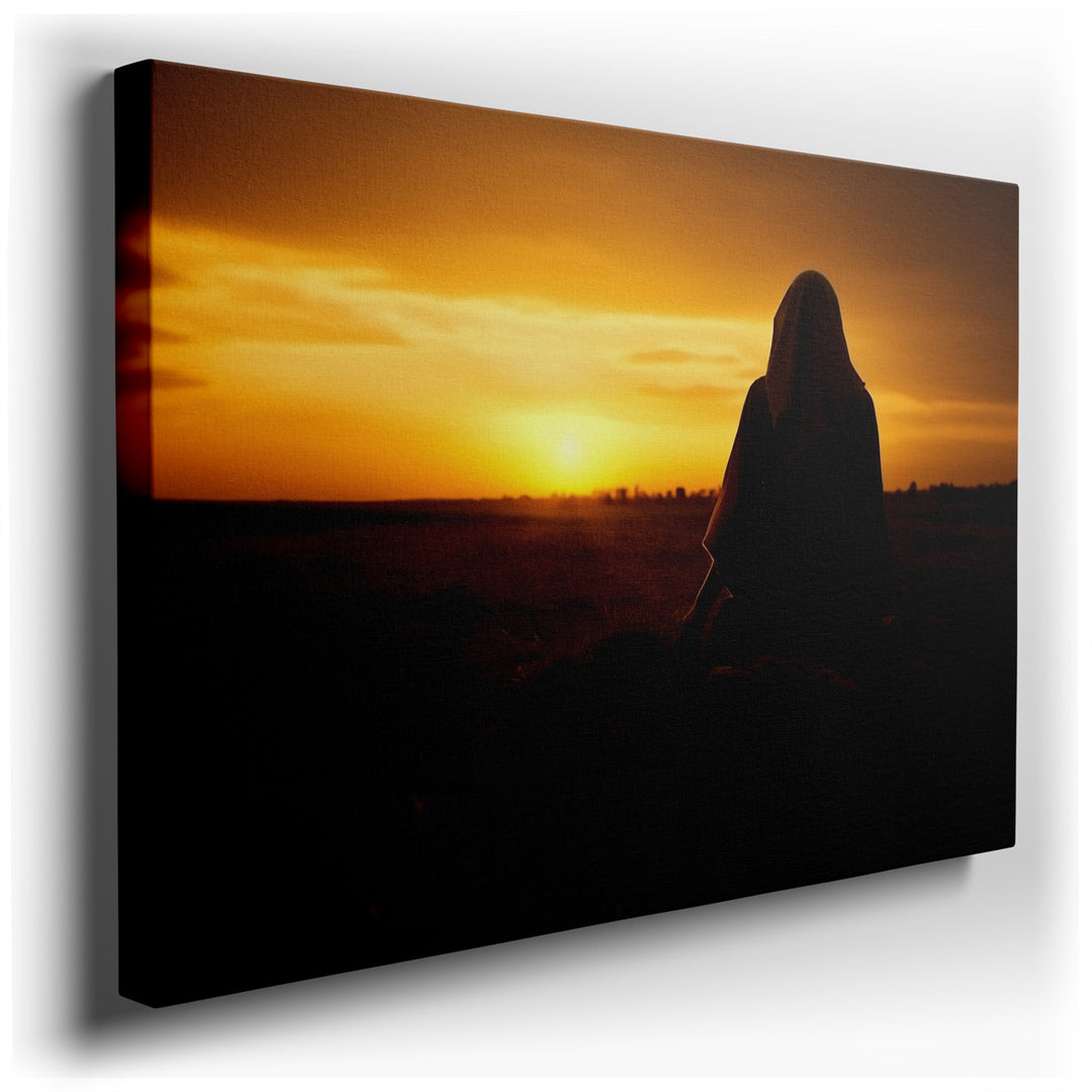 canvas print on wrapped canvas for wall decor – The wall art captures a profoundly serene moment, featuring the silhouette of a woman adorned in a hijab, seated in quie...