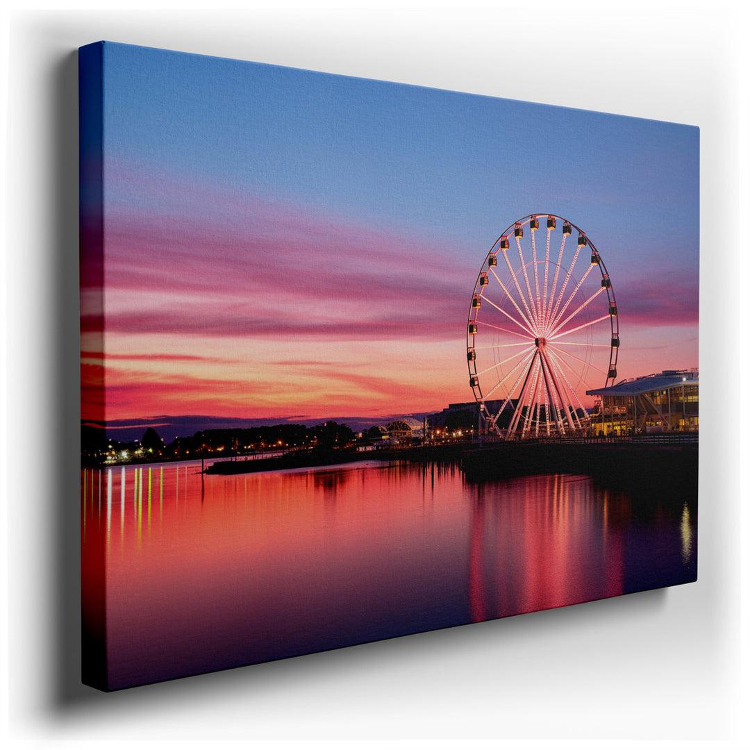 canvas print on wrapped canvas for wall decor – This wall art captures a breathtaking scene of a Ferris wheel situated by the waterfront, illuminated under the enchanti...